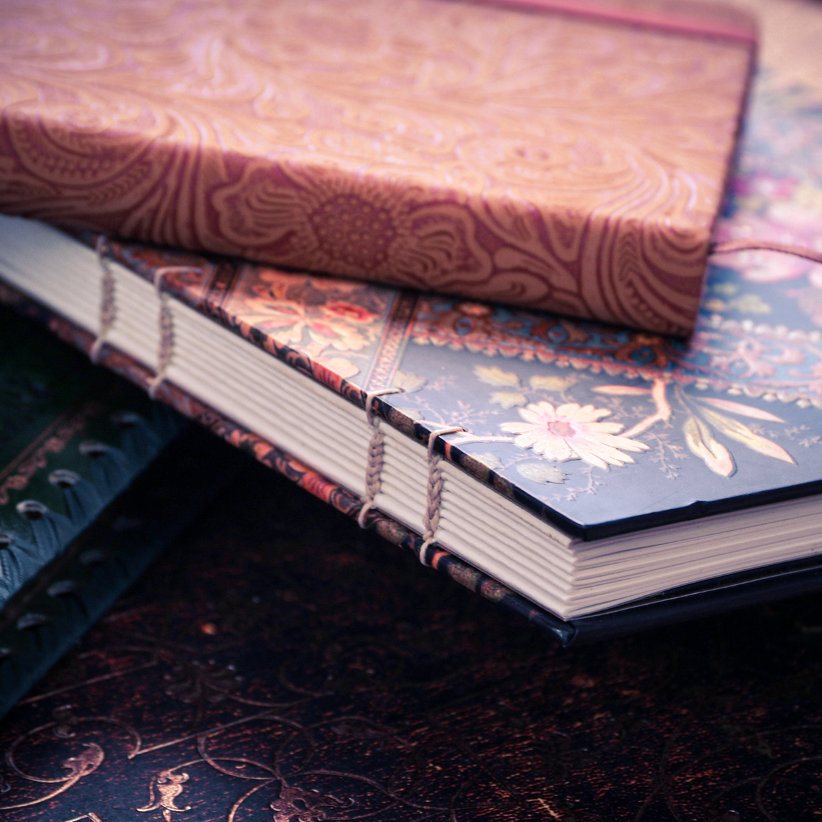 Photo of a stack of floral-covered bound journals.