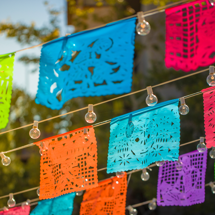 Papel picados -- colorful flags handing on a string of lights 