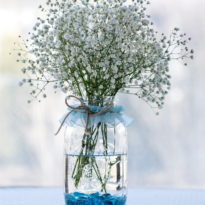 photo of a glass vase filled with baby's breat